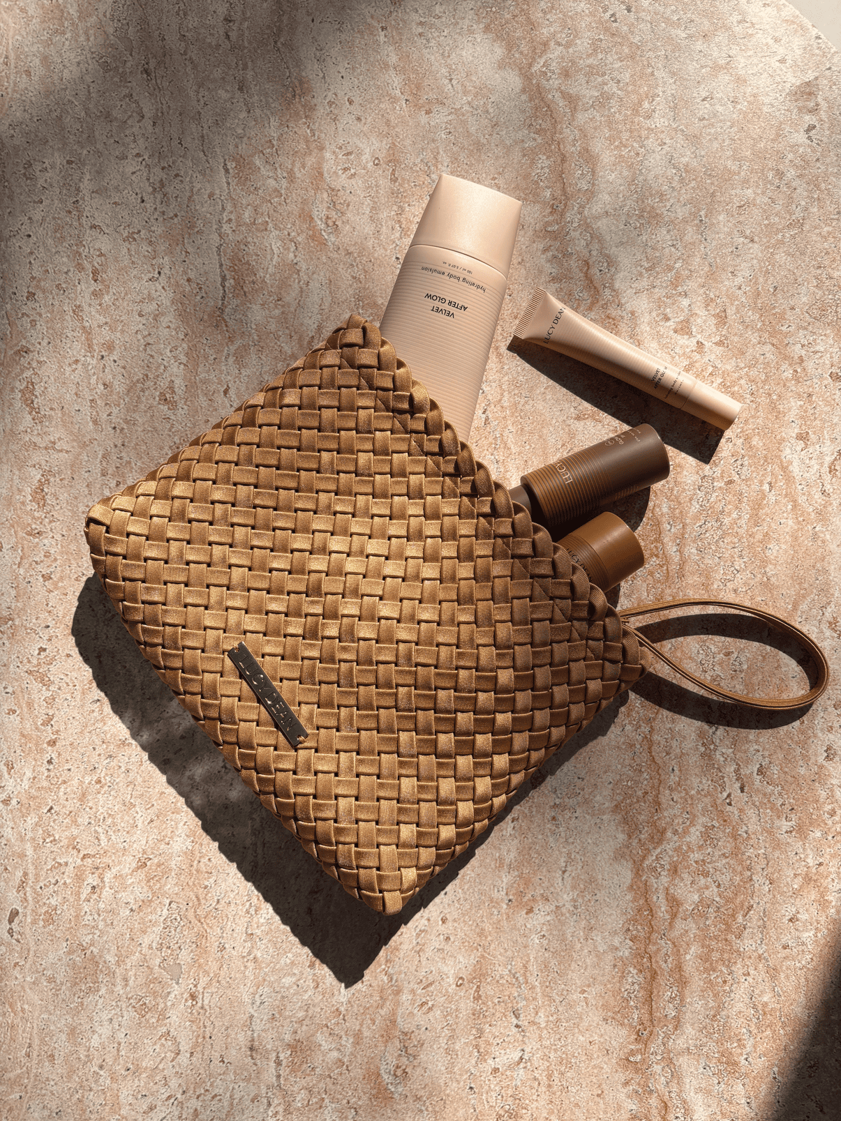 Lucy Dean clutch gold with products flatlay
