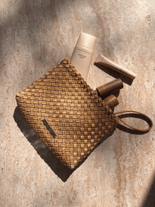 Lucy Dean clutch gold with products flatlay